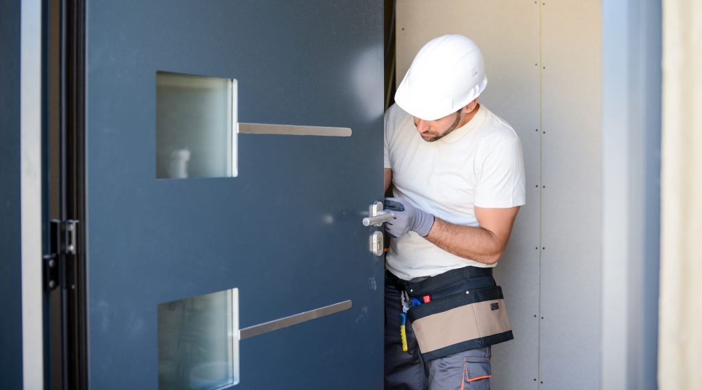 Man installing door in a new house construction site